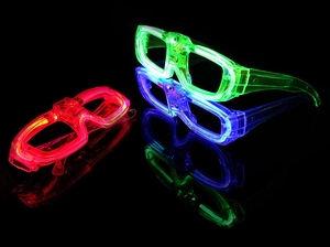 Three LED glowing glasses in red, green, and blue on a reflective black surface