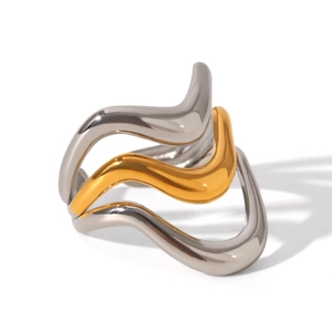 Close-up of modern tri-layer wavy ring featuring mixed silver and gold metallic bands