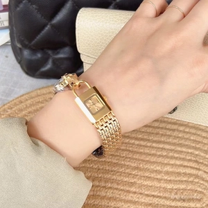 Chic gold padlock watch for women with metallic mesh strap worn on a wrist