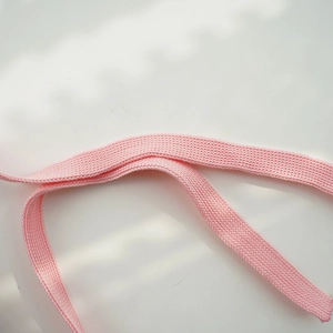 Close-up of pink knitted strap detail for pet party accessories showing fabric texture
