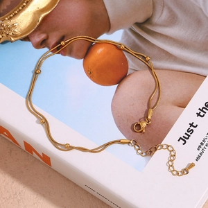 Close-up of 18K gold plated double layer beaded bracelet with adjustable lobster clasp
