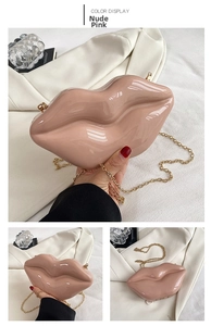 Detail showing the nude pink lip-shaped clutch bag with its stylish golden chain strap