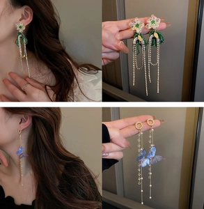 Detail of floral and butterfly long tassel earrings with delicate pearl beads and crystals