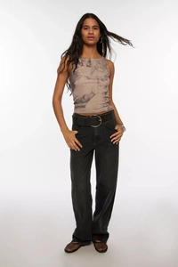 Full view of wide-leg black denim trousers paired with a vintage print sleeveless top