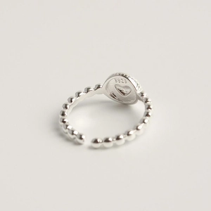 Detailed close-up of S925 sterling silver ring with red heart and engraved S925 stamp