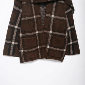 Brown plaid knit cardigan jacket with large checks and pockets in a flat lay view