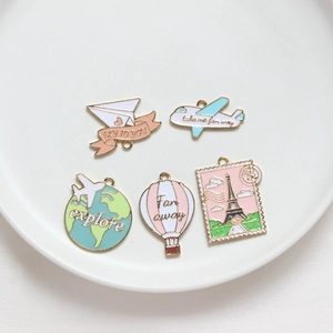 DIY travel themed enamel charms set featuring gold plated airplane and globe pendants