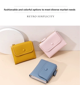 Three retro women's leather wallets in yellow, pink and blue with zippered compartments