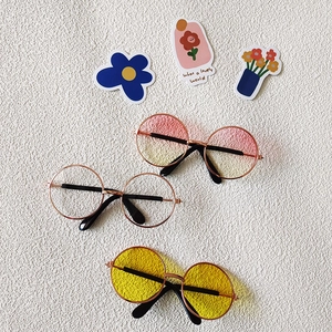 Three pairs of trendy pet sunglasses with colorful lenses and stylish metal frames