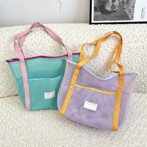 Close-up of contrast mesh beach tote bag featuring large capacity and durable handles