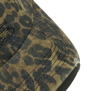 Close-up of leopard print baseball cap featuring distressed holes and side embroidery