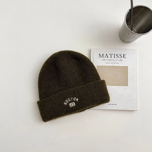 Detail of wool knit beanie with white Boston 23 embroidery on dark olive green fabric