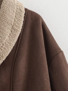 Detail of faux suede jacket showing brown lapel collar and soft lamb wool lining