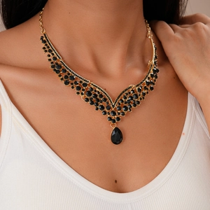 Detail of vintage V-shaped necklace featuring black rhinestones and water drop pendant
