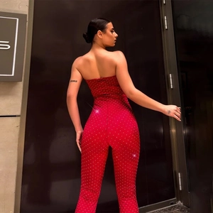 Detail view of red strapless jumpsuit with shimmering rhinestones from a back-side profile