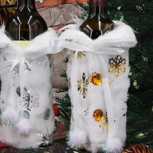 Plush Christmas wine bottle covers with gold and silver snowflakes and ribbon bows