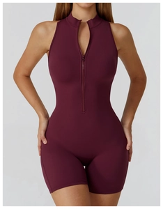 Detail of high-stretch burgundy yoga romper featuring half-zip high neck and sleeveless design