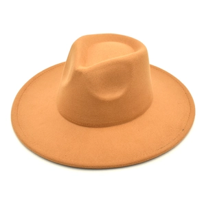 Close-up of a camel wide brim wool fedora hat with a classic pinched crown and felt texture