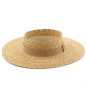 Top view of a wide brim straw boater hat with a camel ribbon for sun protection