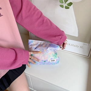 Detailed fabric texture of a floral cotton makeup bag with purple and green oil painting patterns
