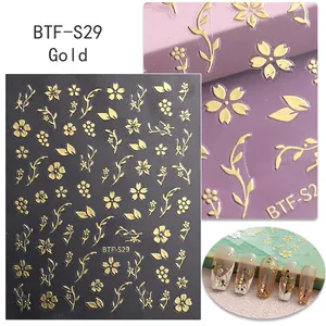 Detail of gold cherry blossom nail art stickers with embossed floral textures and patterns