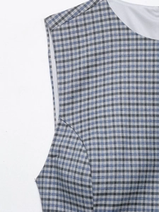 Detail of blue and white checkered fabric featuring a round neck and soft inner lining