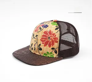 Detail of floral print straw fabric and crocodile pattern leather brim on mesh trucker hat