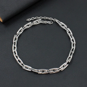 Detailed macro view of silver steel link chain with adjustable lobster clasp closure