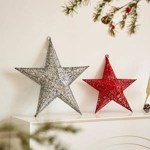 Sparkly red and silver star ornaments on a festive white fireplace mantel decor