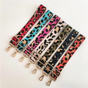 Detail showing seven adjustable leopard print bag straps with gold metal swivel hooks