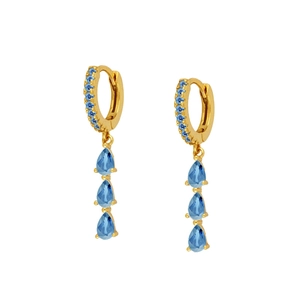 Detail of gold huggie earrings with sky blue round stones and pear-shaped sapphire drops
