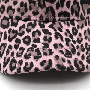 Close-up of pink leopard print baseball cap with suede texture and reinforced stitching