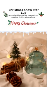 Close-up of a double-walled Christmas tree glass with gold star and snowflake details