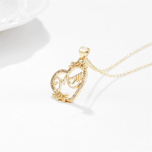 Gold heart MOM pendant necklace with sparkling zircons and delicate chain on white background