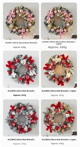 Detail view of pink and red Christmas wreaths in various sizes with warm LED lights