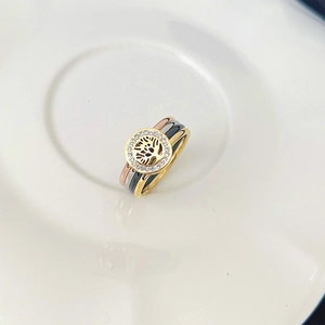 Macro shot of three-tone tree of life ring with sparkling rhinestones in a white bowl