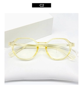 Detailed close-up of octagonal transparent yellow glasses frame on a white soft pouch