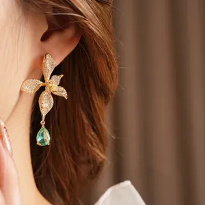 Vintage zircon flower earrings with a green teardrop gemstone in a golden setting