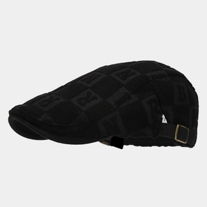 Close-up of retro black newsboy cap with letter jacquard texture and bronze buckle
