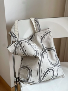 Detail of printed wave pattern and fabric label on a cotton linen tote bag