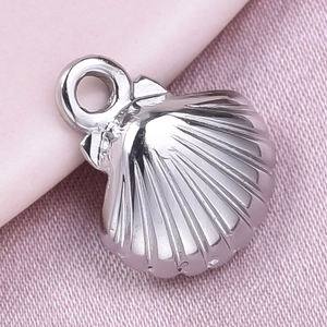 Detailed close-up of a silver shell-shaped pendant in polished 304 stainless steel