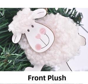 Detail of plush lamb ornament with white faux fur and cute pink cheeks on a green tree