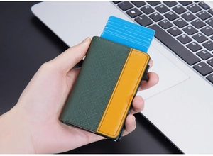 Close-up of leather RFID card holder in green and brown with pop-up cards