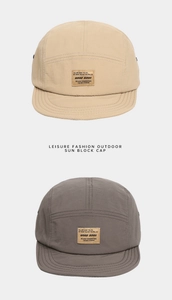 Detail of two quick-dry five-panel camping caps in light brown and dark grey colors