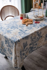 Close-up of blue and gold floral patterns on a rustic linen cotton festive tablecloth