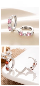 Detail of 12mm silver hoop earrings featuring pink and red heart-shaped zircon stones
