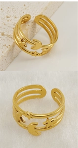 Detail of 18K gold stainless steel triple-layer ring with embossed star and moon motifs