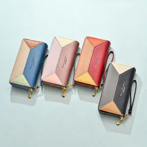 Women's long double zipper wallet with geometric patchwork design and wrist strap