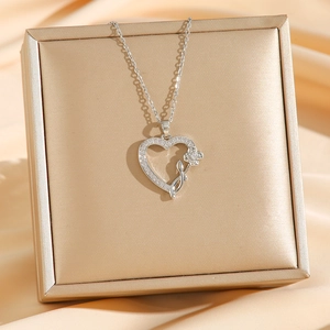 Rose heart titanium steel necklace with micro-paved zircons on elegant satin background