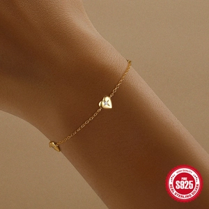 S925 sterling silver heart bracelet in gold with sparkling diamond accents on model